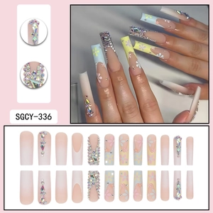 Colorful floral press-on nails with rhinestones and pink gradient in long square shape