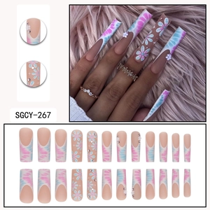 Long coffin press-on nails with blue tie-dye floral patterns and 3D flower accents