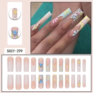 Long trapezoidal French press-on nails with colorful 3D flowers and rhinestones