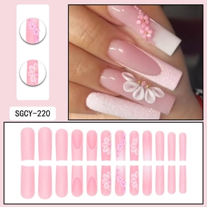 Pink long ballerina press-on nails with white 3D flowers and golden bead decorations