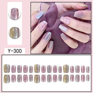 Pink and purple gradient press-on nails with floral patterns and cat-eye glitter effect