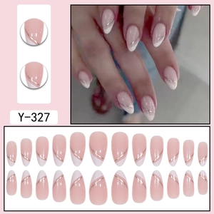 French almond press-on nails in nude and white with elegant gold line accents