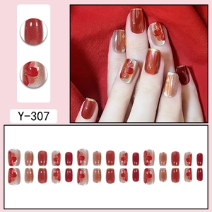 Red festive cat-eye press-on nails set with gold accents and floral hand-painted designs
