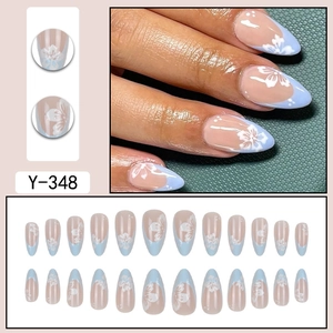 Blue French almond press-on nails with white flower designs in a 24-piece full set