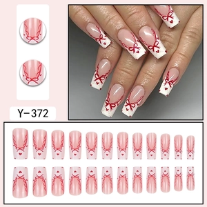 French style press-on nails with red bow and heart patterns in a complete set display