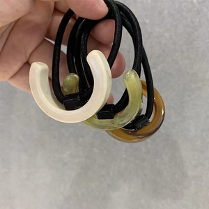 Set of 3 minimalist acetate hair ties with C-shaped resin charms in neutral colors