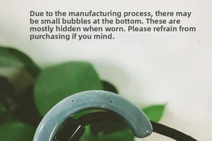 Close-up of semi-circular acetate hair tie with visible natural air bubbles in resin
