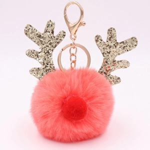 Pink plush reindeer keychain with shiny gold sequin antlers and festive red nose detail
