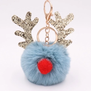 Detailed view of plush blue Christmas reindeer keychain with glitter antlers and gold ring