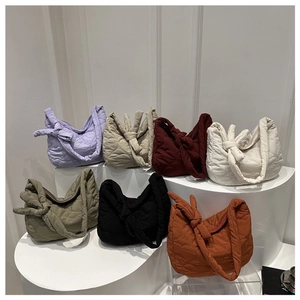 Quilted cloud dumpling bags with knotted handles in various colors on display