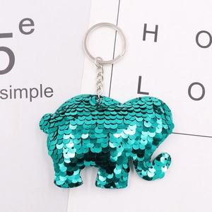 Close-up of green sequined elephant keychain with silver metal ring and chain detail