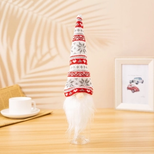 Close-up of knitted gnome wine bottle topper with red heart pattern and plush beard