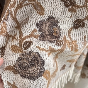 Ethnic jacquard tassel scarf in beige knit with brown floral patterns and warm fringe