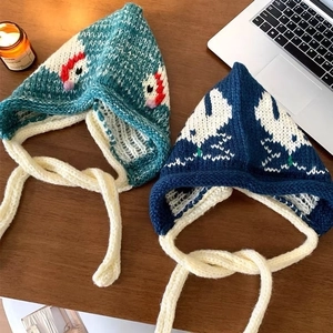 Blue knitted balaclava for women with cute swan pattern and cozy tie-on ear flaps