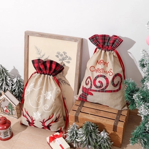 Linen Christmas drawstring gift bags featuring reindeer antlers and holiday snowflake patterns
