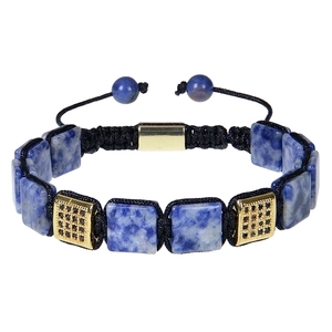 Macro detail of braided bracelet featuring blue natural stones and gold square beads