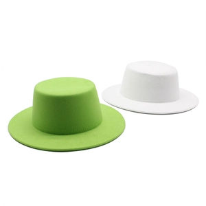 Wool felt boater hats in lime green and white colors with wide flat brims and stiff crowns