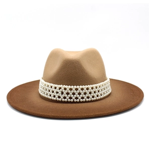 Close-up of brown wool jazz hat featuring elegant white pearl woven ribbon decoration