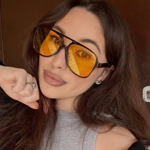 Classic aviator sunglasses with black double-bridge frame and orange tinted lenses