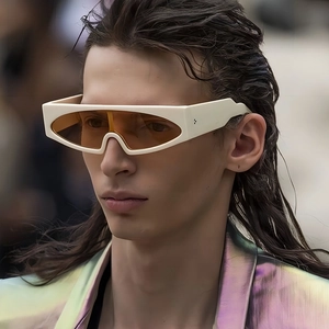 Retro futuristic oversized sunglasses with wide beige frames and orange tinted lenses