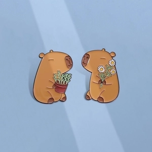 Cute capybara enamel pin set featuring cartoon animals holding flowers and plants
