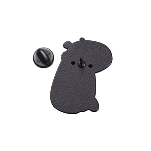 Close-up of matte black metal back of capybara enamel pin with rubber clutch