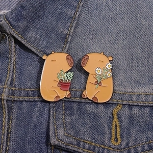 Cute Capybara enamel pins set of 2 for backpacks shown on a blue denim jacket pocket