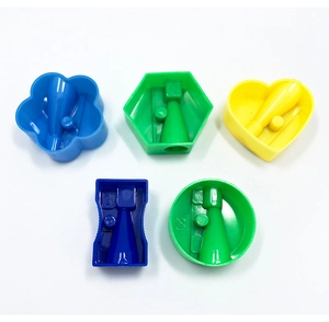 Close-up of colorful plastic pencil sharpeners in flower, heart and hex shapes