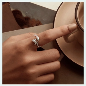 Detail of s925 silver adjustable open ring featuring vintage rose and snake with green eyes