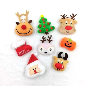 Detail of plush Christmas charms including reindeer, Santa Claus, and embroidered holiday socks