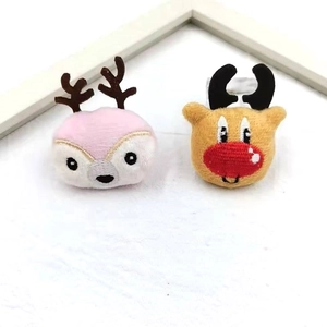 Detailed view of plush reindeer ornaments with fine embroidery and small rings for DIY