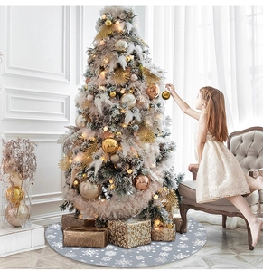 Detail of 122cm grey Christmas tree skirt with white snowflake patterns in a cozy scene