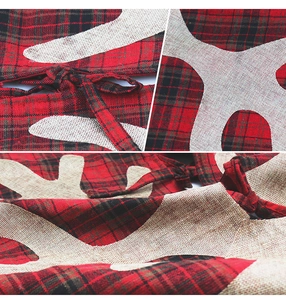Macro detail of red and black plaid fabric with burlap snowflake applique for tree skirt