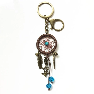 Detailed handmade dreamcatcher keychain with turquoise beads, feathers and deer charm
