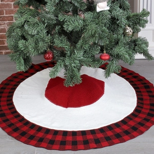Detail of red and white knit Christmas tree skirt with classic buffalo plaid border