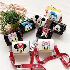 Close-up of children's Disney cartoon crossbody bags with patterned red shoulder straps