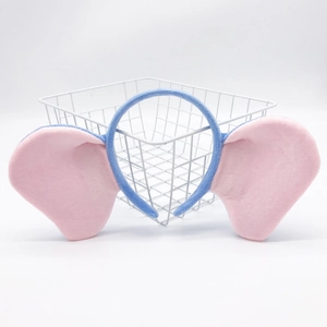 Detail of plush elephant ear headband in pink and blue soft fabric for kids
