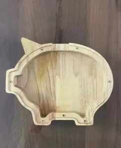 Detail of wooden pig money box showing smooth rubber wood grain and screw holes