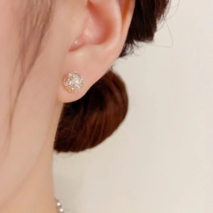 Elegant sphere stud earrings with sparkling cubic zirconia set in gold finish on model