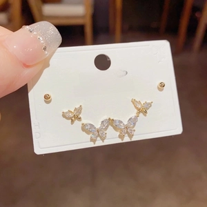 Sparkling butterfly stud earrings with clear zircon stones on a golden setting for women
