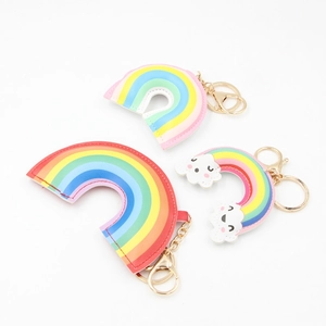 Set of colorful PU leather rainbow keychains with golden metal clasps on white background
