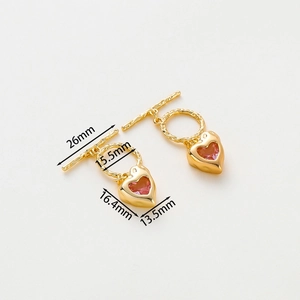 Macro detail of 14k gold-plated heart pendant with pink gemstone and toggle clasp size specs
