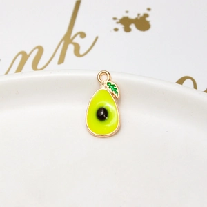 Macro shot of an avocado-shaped alloy pendant with gold plating for jewelry DIY