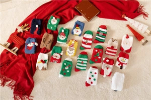 Flat lay of colorful Christmas fuzzy socks with Santa and reindeer patterns on a cozy rug