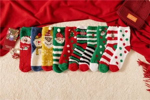 Flat lay of colorful Christmas coral fleece socks with festive snowman and reindeer patterns