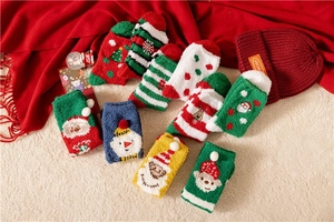 Close-up of thick coral fleece Christmas socks with festive patterns and soft textures