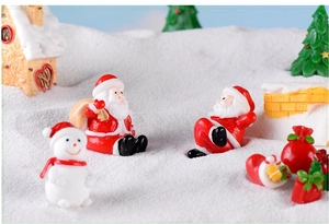 Detailed view of Christmas miniatures featuring Santa and snowman in a snowy scene