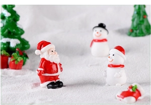 Detailed view of resin Santa, snowmen, and Christmas tree miniature landscape ornaments