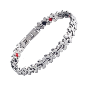 Titanium magnetic bracelet with flower links and red black dots on white background