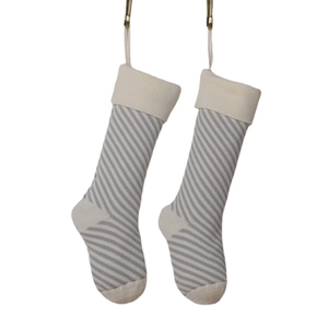 Knitted Christmas stockings with grey and white stripes for holiday gift decoration